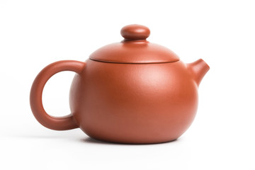 Small brown earthenware teapot with closed lid isolated on white
