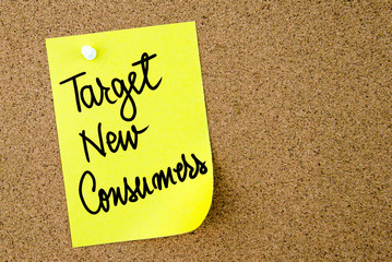 Target New Consumers text written on yellow paper note