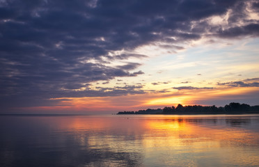 Beautiful landscape with sunset fiery sky and sea. 