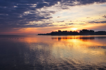 Beautiful landscape with sunset fiery sky and sea. 