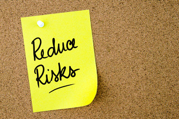 Reduce Risks text written on yellow paper note