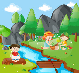 Naklejka premium Children planting tree in the forest