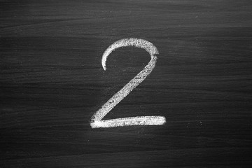 number two enumeration written with a chalk on the blackboard