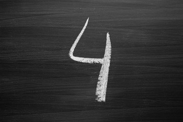 number four enumeration written with a chalk on the blackboard