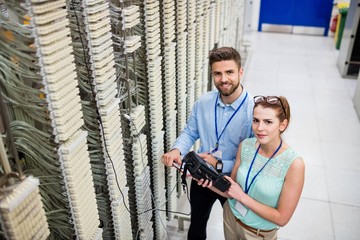 Technicians using digital cable analyzer © WavebreakmediaMicro