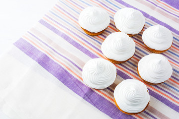 Obraz na płótnie Canvas Birthday cupcakes with white whipped cream, top view, copy space
