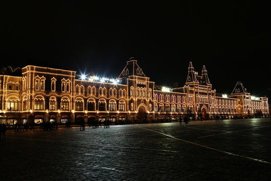 Moscow, Russia: Main Department Store (GUM) at the Red Square by winter evening with Christmas illumination and people silhouettes in front of it