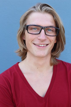 Portrait of casual blonde young man wearing glasses and red v-neck t-shirt