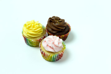 3 homemade cupcakes isolated on a white background