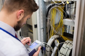 Technician using digital cable analyzer - Powered by Adobe