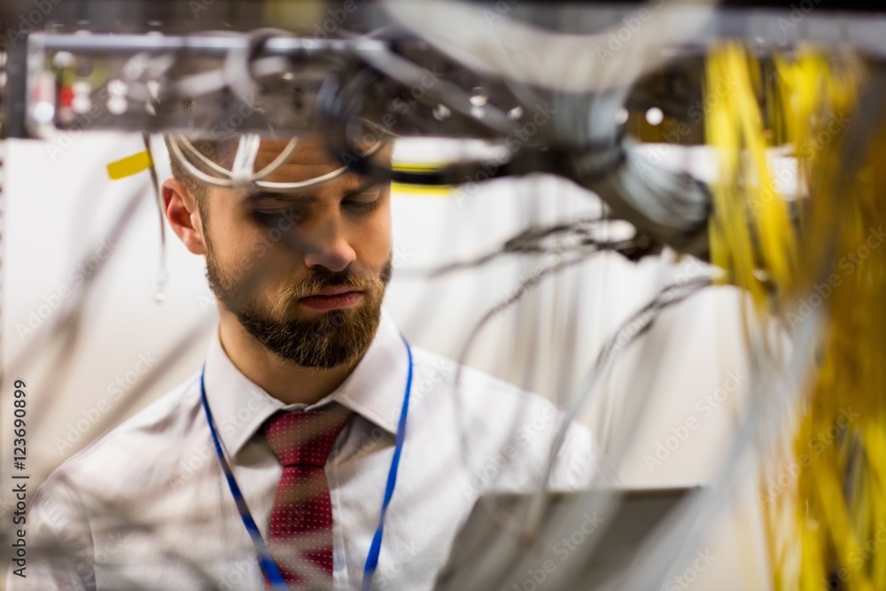 Aufkleber Technician using digital tablet while analyzing server