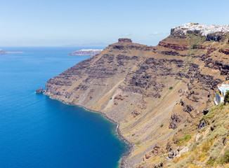 Charming Oia village in last rays of sunset.Panoramic view from a height above the houses, villas and the Mediterranean sea.Beautiful natural landscape.Santorini Thira island.Cyclades.Greece.Europe.