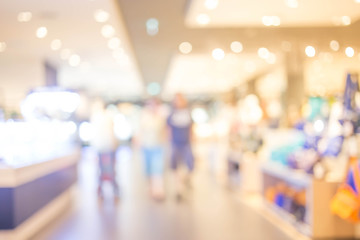 blurred image of shopping mall and people .