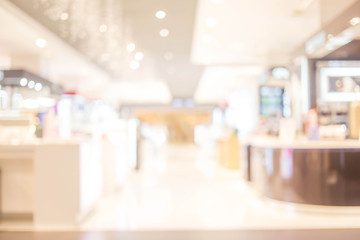 blurred image of shopping mall and people .
