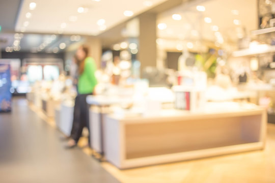blurred image of shopping mall and people .