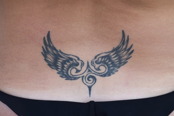 The tattoo in the shape of wings on the back