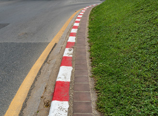 Red and white concrete road curb