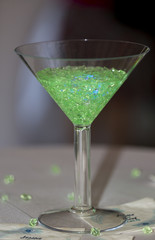 Martini glass full of green stones or glitter