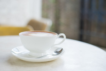 Laptop and coffee cup on wooden table