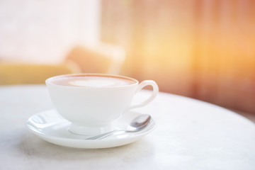 Laptop and coffee cup on wooden table