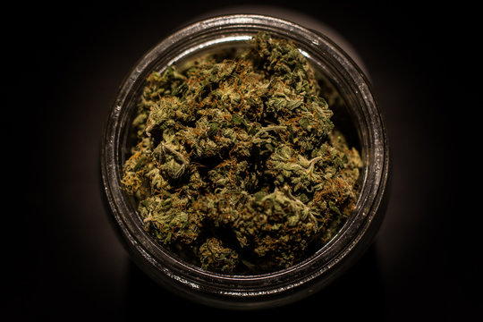 Marijuana or cannabis jars of dried flower bud isolated black background