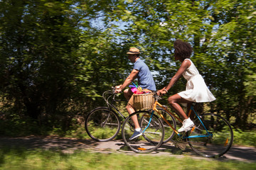 Young multiethnic couple having a bike ride in nature