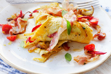 Omelet with bacon and vegetables for a healthy breakfast