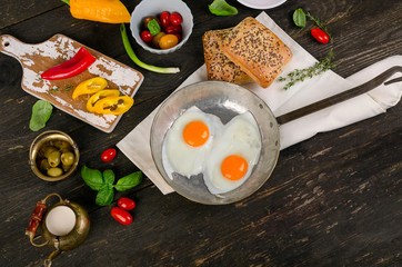 Fried eggs on wooden table for Healthy breakfast.