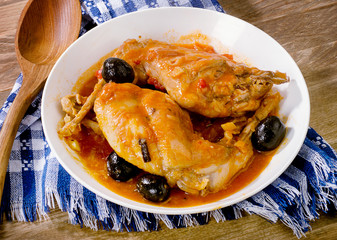 Stewed rabbit legs with olives.