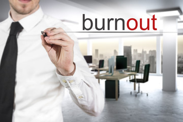 businessman in modern office writing burnout