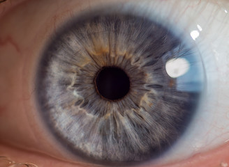 Blue man eye with contact lens, macro shot. Shallow depth of field.