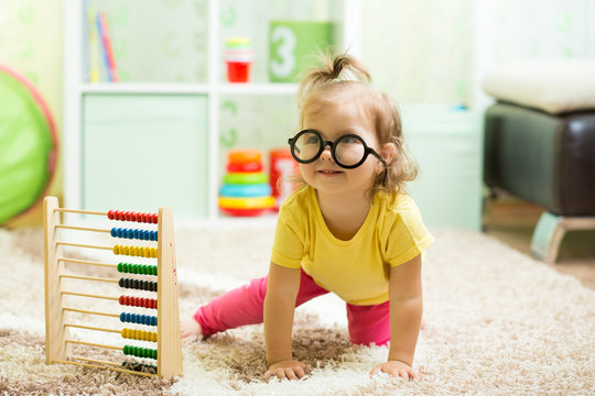 funny baby weared glasses with counter toy