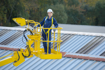 Woman in cherry picker bucket