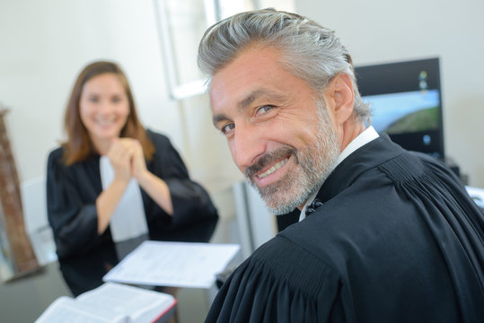 Portrait of male and female lawyers in robes