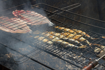 Fried fish on a hot coal.