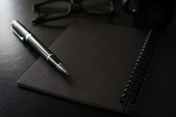 Black notebook with copyspace and cup of coffee