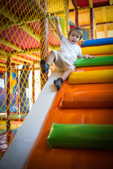 Obraz na płótnie Canvas Little kid climbing on stairs in kindergarden playground
