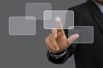 Businessman in black suit pointing on virtual screen.