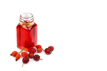 Bottle of rose hip oil on white background
