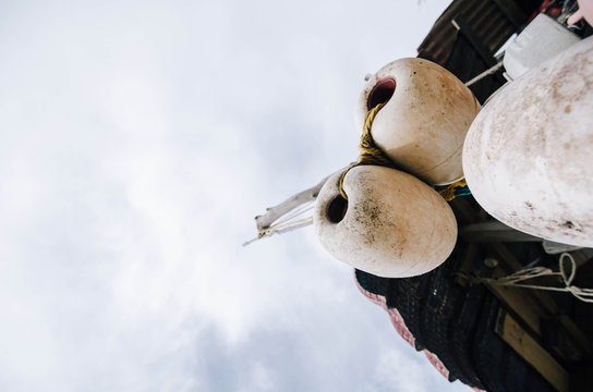 close up and lower angle image group of dirty white fish net buo