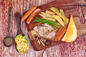 Home made ,Pork steak and mixed vegetables on butcher served served with side dish as parmesan cheese bread ,sausage ,shiitake fresh mushroom soup and salad.
