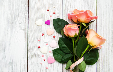 Pink roses on a wooden background