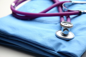 Doctor coat with stethoscope on the desk