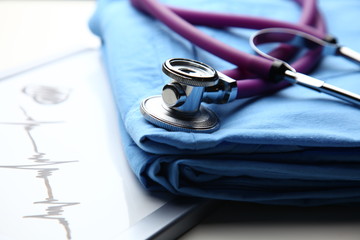 Doctor coat with stethoscope on the desk