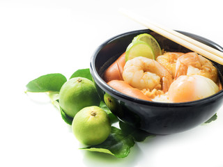 noodles with tom yum soup isolated, lime and Kaffir lime leaves