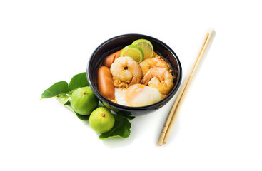noodles with tom yum soup isolated, lime and Kaffir lime leaves