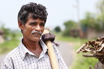 Indian Senior Man Holding Grub Hoe