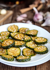 Slices of pickled cucumbers with sesame seeds