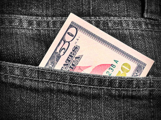 Obraz premium Fifty dollars in jeans pocket