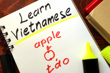 Learn vietnamese written in a notepad.  Education concept.
